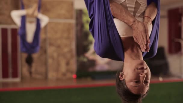 Anti-zwaartekracht Yoga, vrouw doen yoga oefeningen binnen — Stockvideo