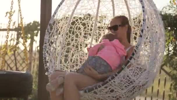 Mom and little daughter having fun on the swing — Stock Video