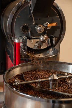 Kızarmış kahve. Kavurma makinesinde kahve çekirdekleri. Kesik atış, yakın çekim, yatay, arka plan. Üretim ve endüstri kavramı