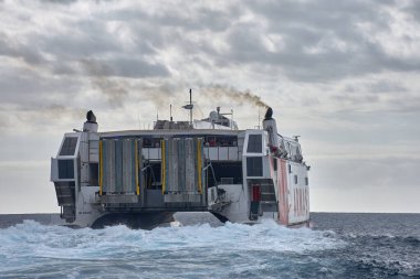Tenerife, İspanya, 14 Ocak 2026 Volkan de Tirajana 'nın heybetli kırmızı ve beyaz gövdesi yüksek hızlı katamaran okyanus dalgalarını teknik hassasiyetle keser..