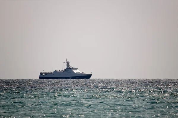 Военный корабль патрулирует береговую линию — стоковое фото