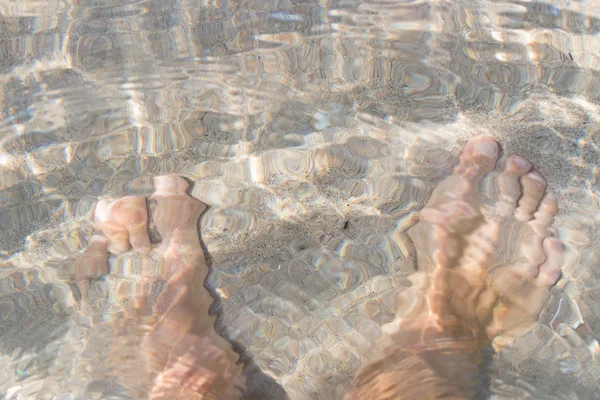 Feet in the clear sea water — Stock Photo, Image