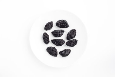 Bir tabak beyaz arka plan üzerinde kuru erik