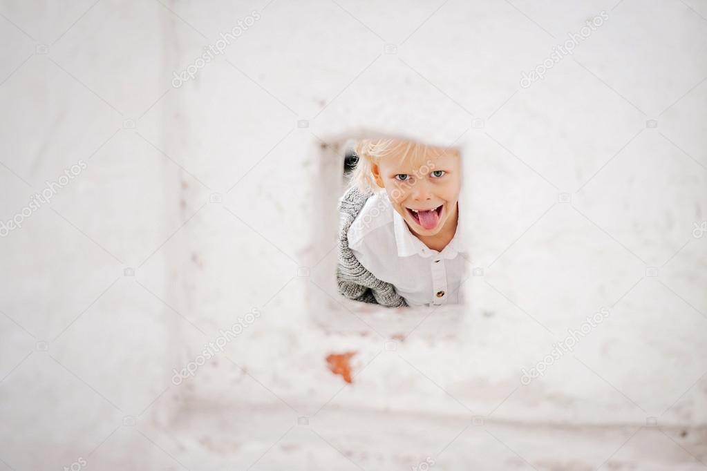 little boy showing his tongue