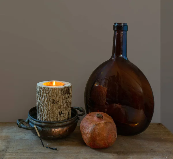 Still Life Burning Candles Ripe Pomegranate Large Glass Bottle Vintage — Stock Photo, Image