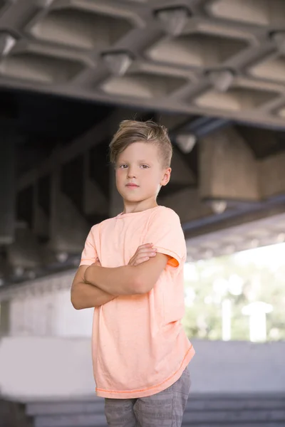 Garçon à la mode plié ses mains et regarde fièrement  . — Photo