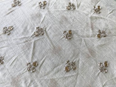 Üç aşamalı karmaşık bir motif gümüş ipliklerle parıldıyor, el değmemiş beyaz Chanderi kumaşına özenle işlenmiş..