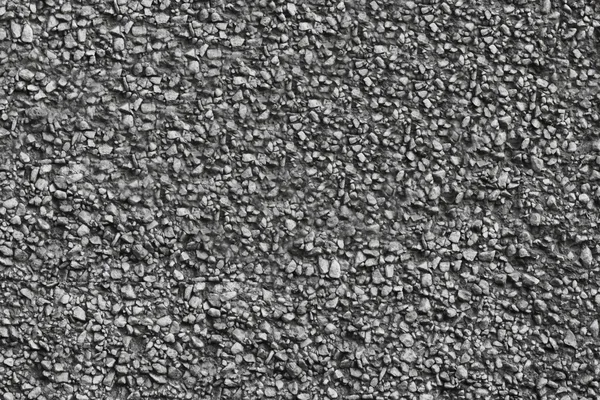 Texture of concrete wall covered with stones