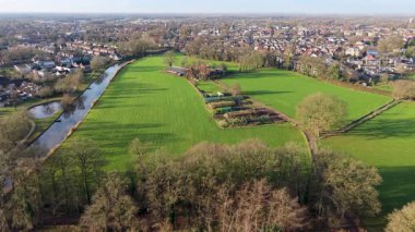 Hollanda 'nın yarı kırsal bölge çiftliği, kanal, ağaçlık yol ve yoğun şehir manzarası arazi kullanımının tarımdan banliyö gelişimine geçişini gösteriyor.