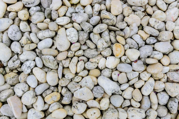 Pedras arredondadas branco e cinza na praia como fundo . — Fotografia de Stock