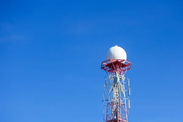 Radar dome in the sea with blue sky and clouds.