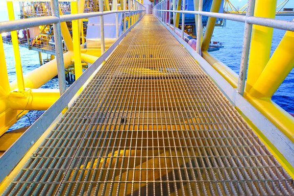 Bridge and handrail with grating on offshore platform with light