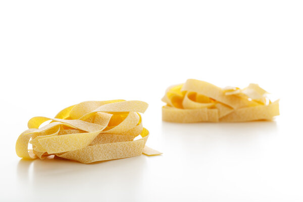 Pappardelle pasta on white background
