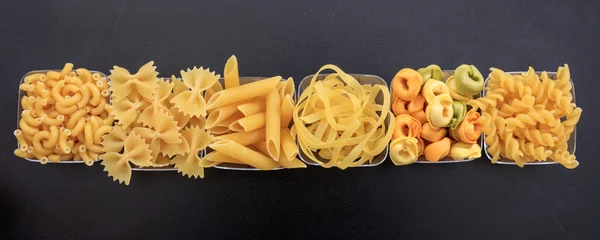 Row of various shapes of pasta — Stock Photo, Image