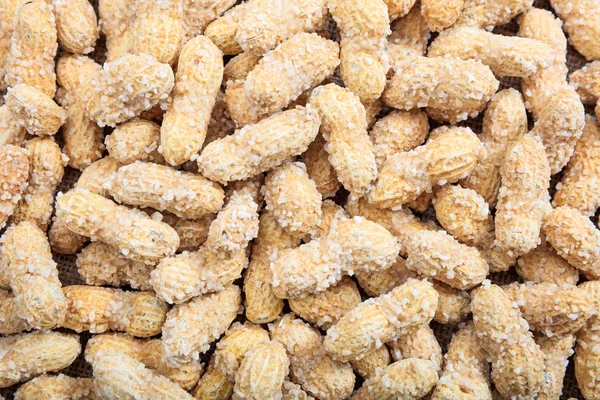 Erdnüsse in der Schale als Hintergrund — Stockfoto