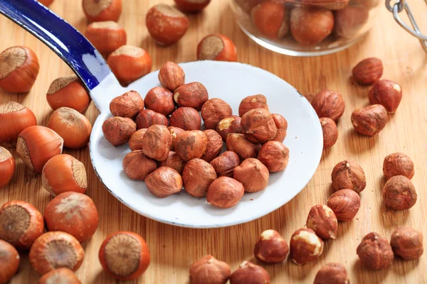 Hazelnuts and an old ladle — Stock Photo, Image