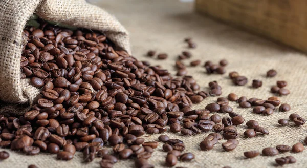 Coffee beans out of a sack — Stock Photo, Image