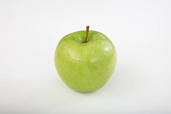 Zelené jablko na bílém pozadí Stock Snímky