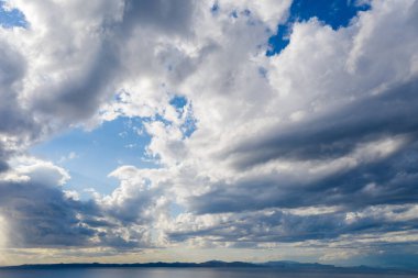 Kea, Tzia Adası, Yunanistan. Güneş ışınları bulutları boyuyor Akdeniz 'i gümüş rengine boyuyor. Güneş suya, nemli çevreye yansıyor..