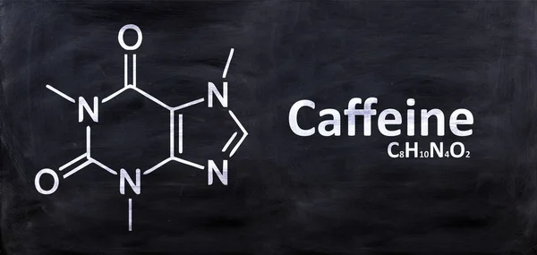 Caffeine structural chemical formula, drawing on a chalk black board, School chemistry class. Stimulant substance in coffee and tea