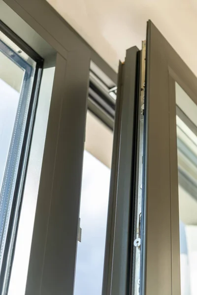 Window aluminum open detail. Metal or PVC door frame vertical closeup view. Energy efficient, security profile, Tilt and turn window, fresh air for home