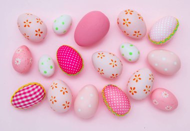 Happy Easter greeting card template. Easter eggs collection pink pastel color on pink background, top view. Christian religion holiday celebration and decoration.
