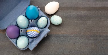 Happy Easter greeting card template. Easter eggs collection blue pastel color on wooden blue background, top view. Christian religion holiday celebration and decoration.