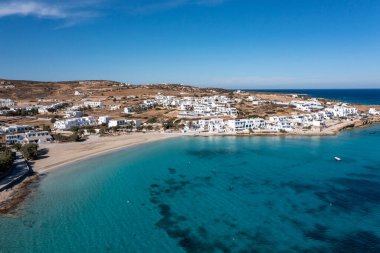 Greece, Koufonisi island, small Cyclades. Aerial drone view. Pano Koufonisi white traditional village buildings, Megali Ammos sandy beach. Calm turquise sea water, clear blue sky background clipart