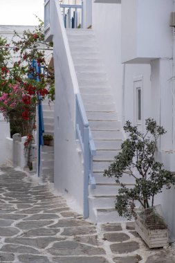 Mykonos island, Greece. Whitewashed buildings, narrow cobblestone street. Chora village traditional architecture in white and blue colors. Summer vacations destination, Cyclades
