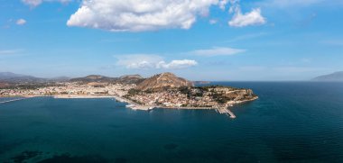 Nafplio or Nafplion city, Greece, Aerial drone panoramic view. Peloponnese old town cityscape, Palamidi castle uphill, yachts and boats moored at the dock. Blue sky with clouds background. clipart