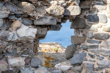 Cyclades Greece. Aegean blue sea through an opening on rock wall. Serifos island, Sunny day, summer vacation. 