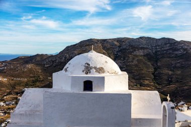 Church dome, small whitewashed old chapel, climbed on rocky mountain at Serifos island over Chora, Cyclades Greece. Summer vacation destination