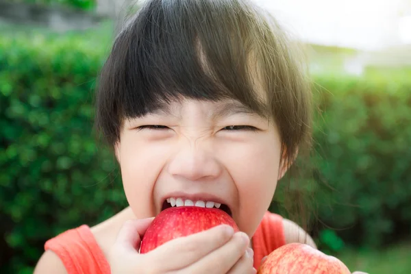 Funny food little girl with red Apple smiling happy. Healthy eating and vegetables concept photo