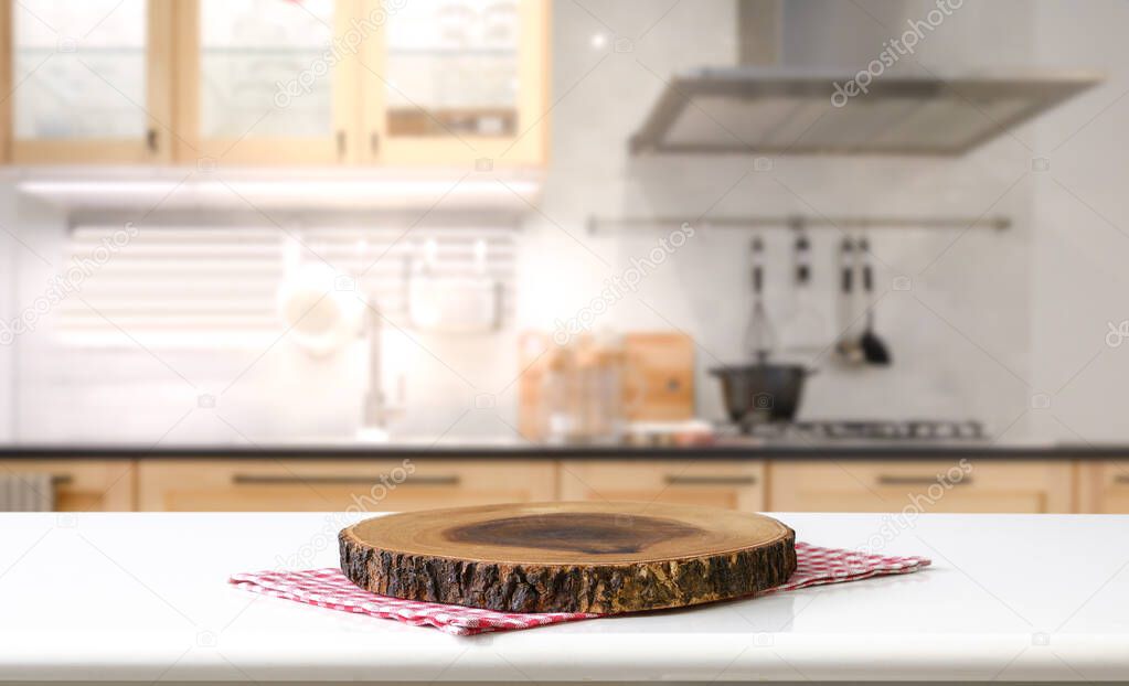 Empty cutting board on a wooden table and blurred kitchen background	