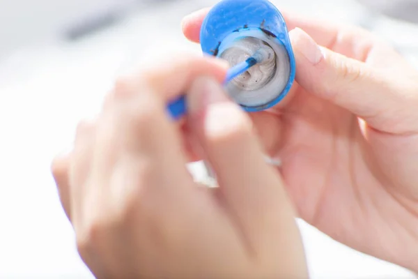 Young woman mixing paint for  eyebrows