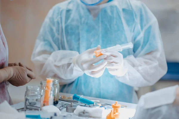 preparation of fat cells for lipofilling in the operating room. Surgical cosmetic surgery to rejuvenate the face with the introduction of stem and fat cells.