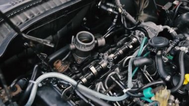 footage of car parts and car mechanic checking the condition of the car 