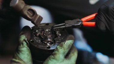 footage of car parts and car mechanic checking the condition of the car 