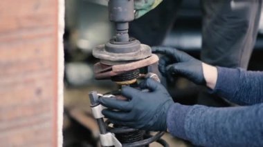 footage of car parts and car mechanic checking the condition of the car 