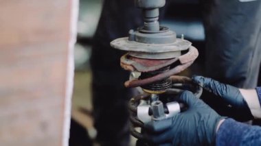 footage of car parts and car mechanic checking the condition of the car 