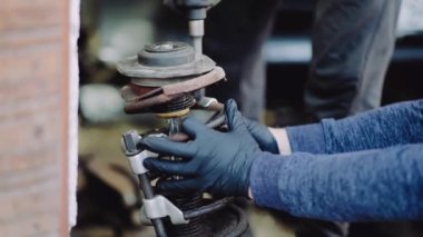 footage of car parts and car mechanic checking the condition of the car 