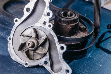 Kullanılmış otomobil parçaları, soğutucu pompası ve tekerlek merkezi. Araba tamiri kavramı.