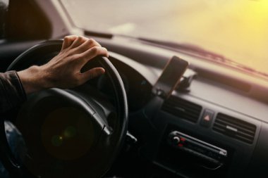 Sürücü güneşli bir günde araba sürer.
