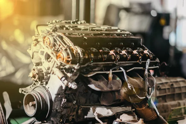 disassembled car engine, valve cover replacement, valve adjustment and chain tension.