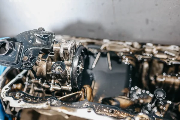 oil pump in the oil pan of a car engine.