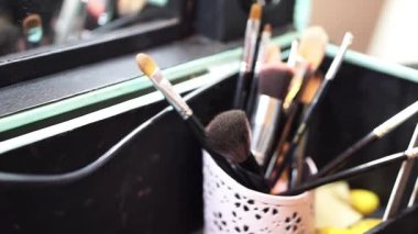 A short video featuring a variety of cosmetic brushes arranged in a stylish case. This makeup toolkit highlights the themes of beauty, art, and careful preparation.