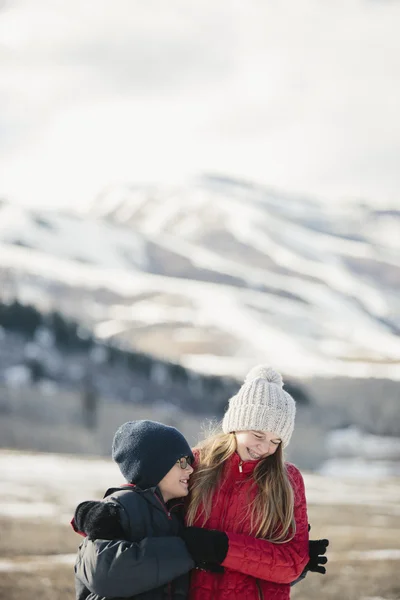 Brother and sister hugging and laughing — Stock Photo, Image