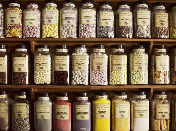 Sweets displayed in tall glass jars — Stock Photo