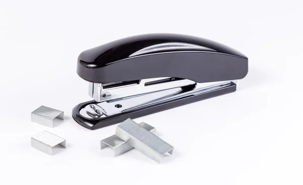 Black stapler and staples on white — Stock Photo, Image