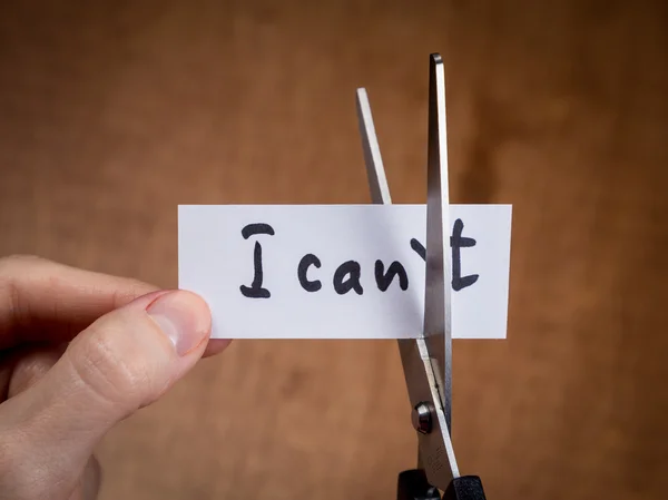Scissors cutting negative label, self motivation concept